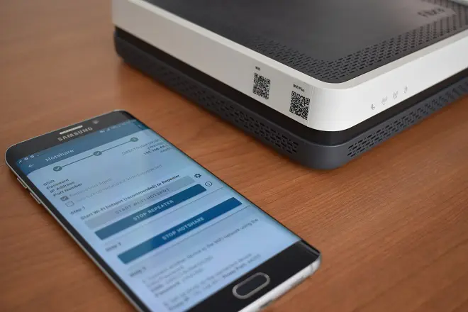 Smartphone next to a router to repeat the Wi-Fi signal